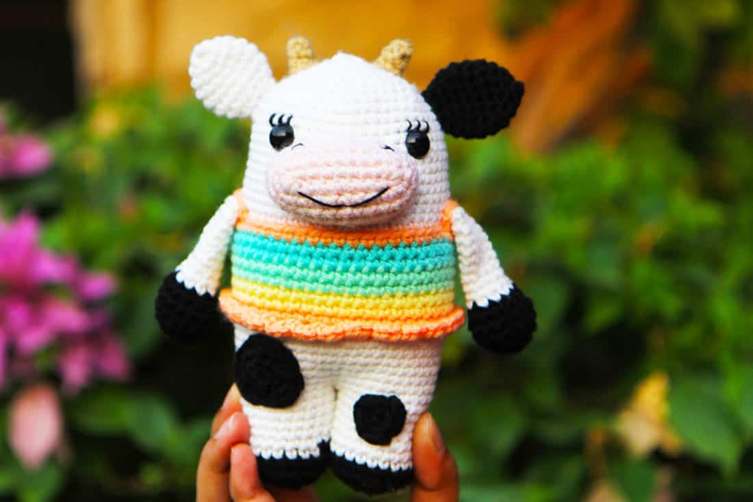 crochet cow in a colourful tank top